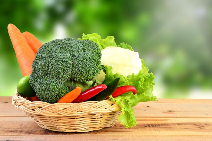 Vegetables in a wicker basket with carrots and broccoli