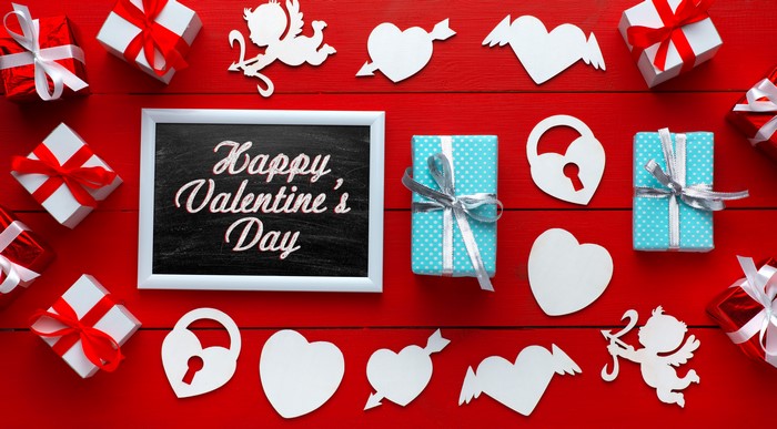 Valentine's Day gifts and decorations on red background