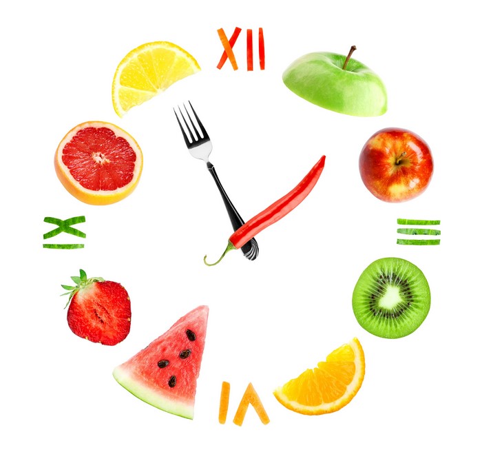 Creative clock face made of fruits and vegetables