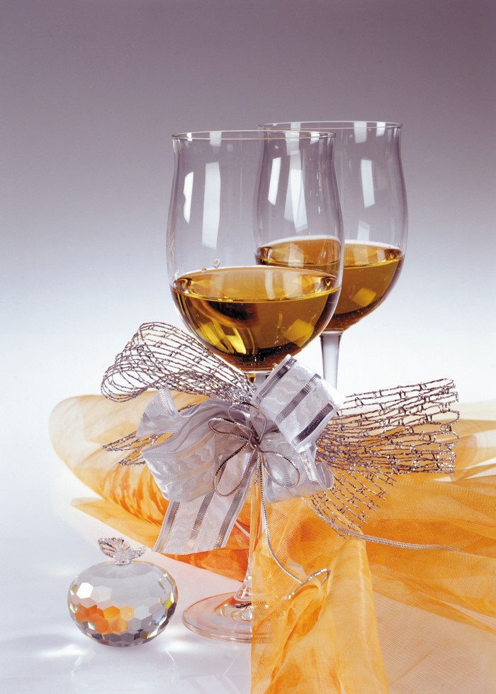 Two glasses of white wine with a decorative bow
