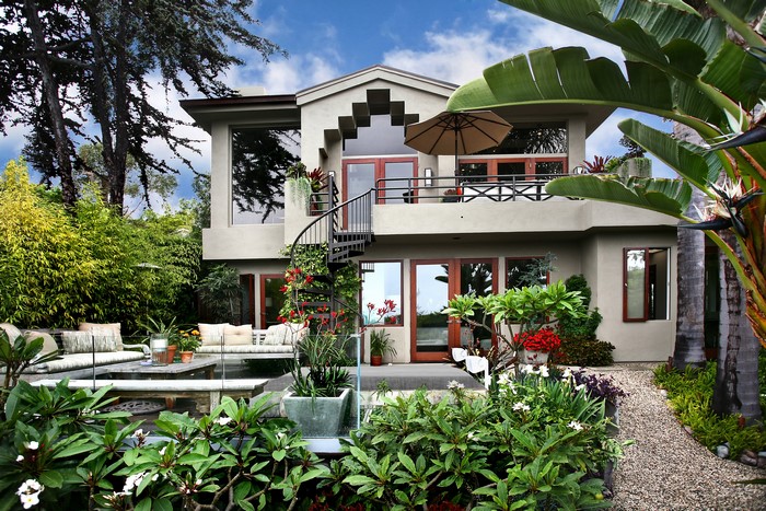 Modern house with spiral staircase and lush garden
