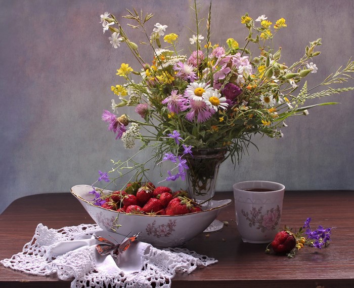 Still-life with bouquet of wildflowers and strawberries