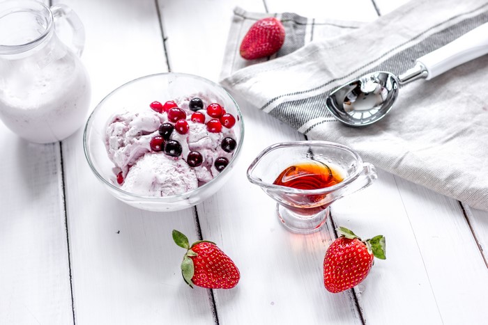 Ice cream with berries and syrup
