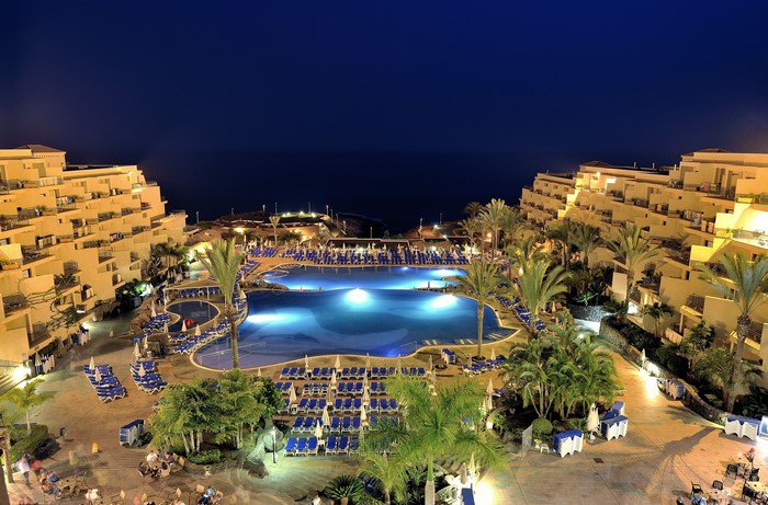Resort with pools and ocean view at night in Tenerife