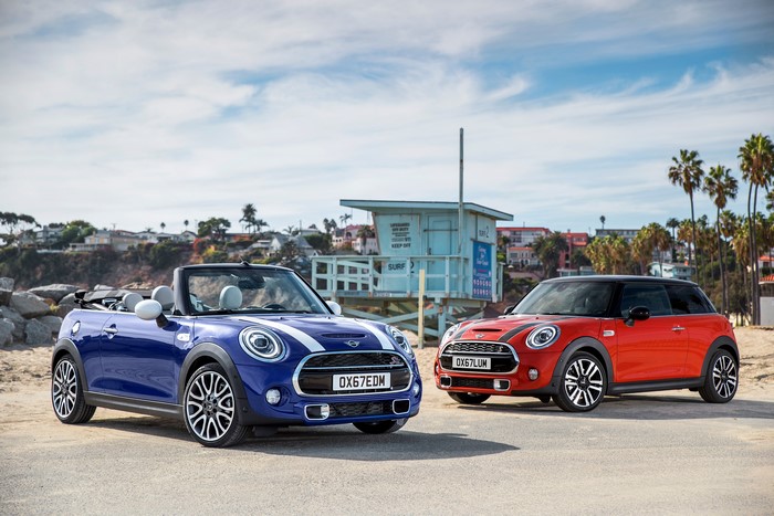 Two Mini Cooper S cars on a beach