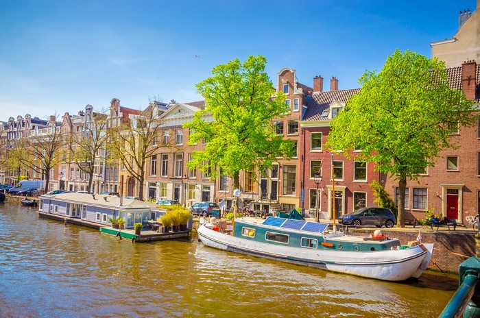 Amsterdam Canal with Houseboats and Buildings