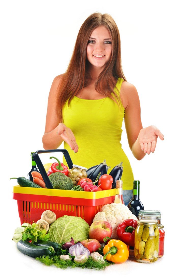 Woman with a basket of fresh vegetables and fruits