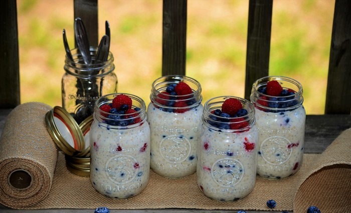 Four jars of overnight oats with berries