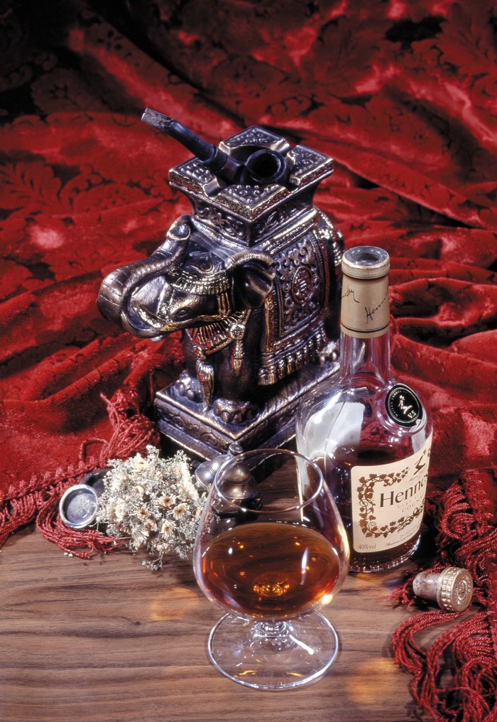 Hennessy bottle, glass, and pipe on elephant ashtray