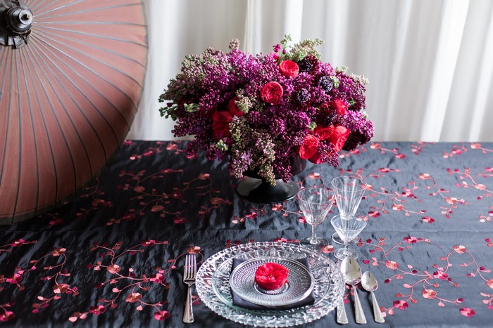 Table setting with floral arrangement and umbrella