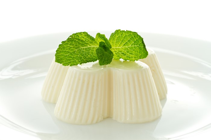 White gelatin desserts with mint on a plate