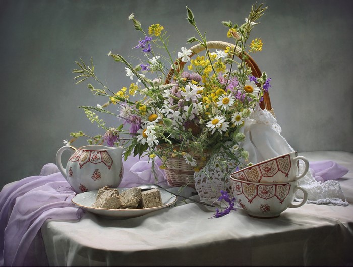 Still-life with wildflowers, sweets, and teacups