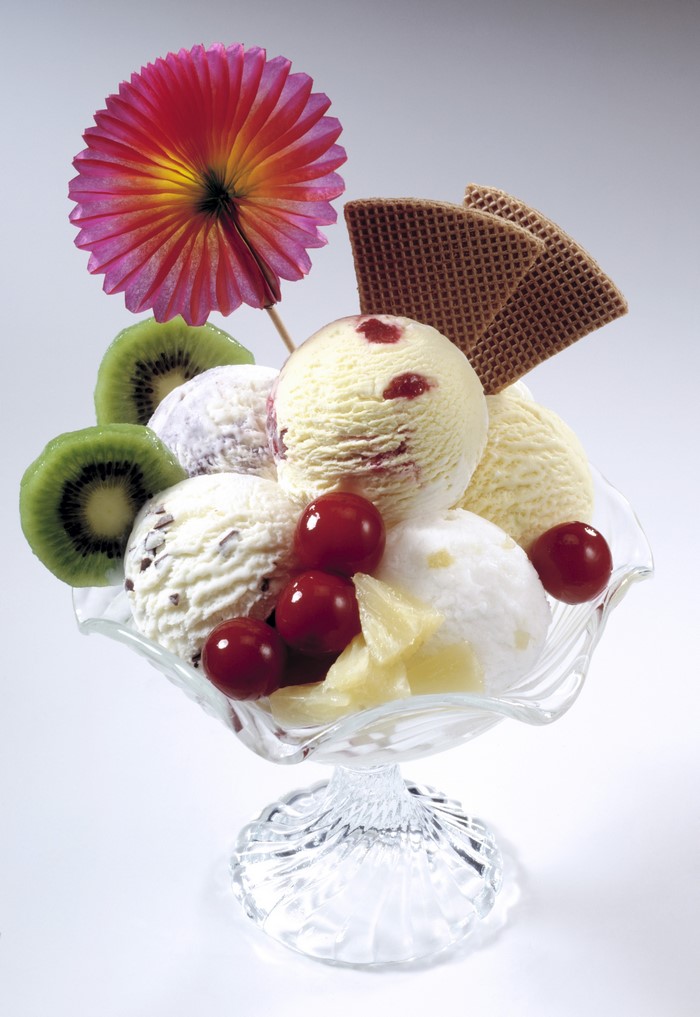 Ice cream sundae with kiwi, cherries, and wafers
