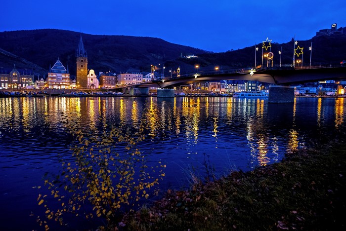 Town on Moselle River at night with bridge