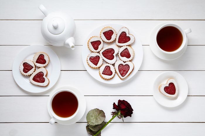 Tea set with heart-shaped cookies and a rose