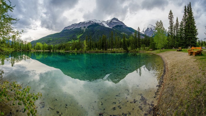 Mountains reflected in a clear turquoise lake
