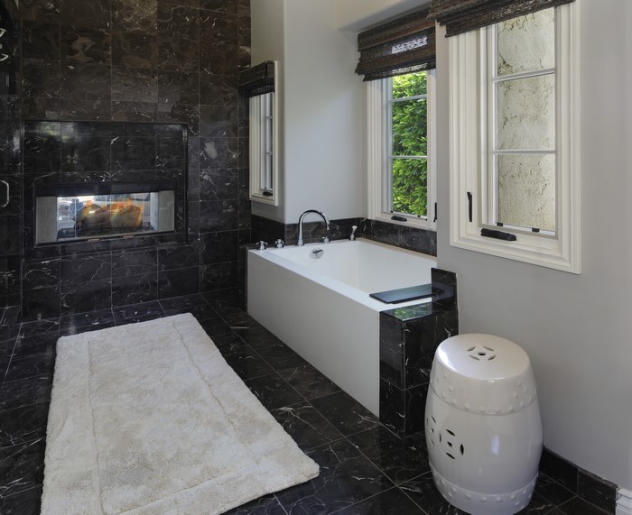 Luxury bathroom with fireplace and bathtub