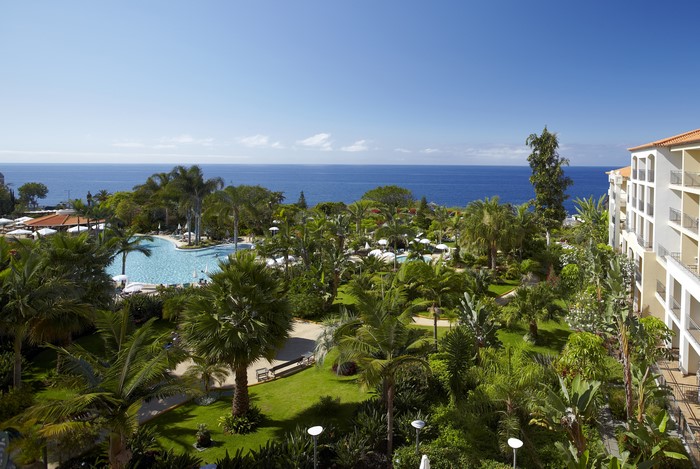 Resort with pool and palm trees overlooking the ocean in Madeira, Portugal