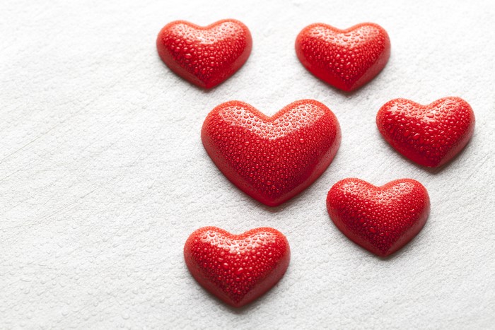 Red Hearts with Water Drops on White Background