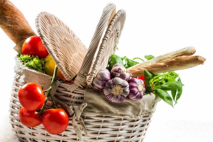 Wicker basket filled with fresh vegetables and bread
