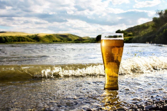 Beer in a highball glass by the water