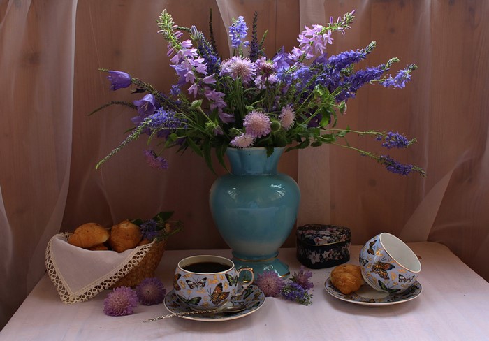 Still-life with flowers, coffee, and pastries