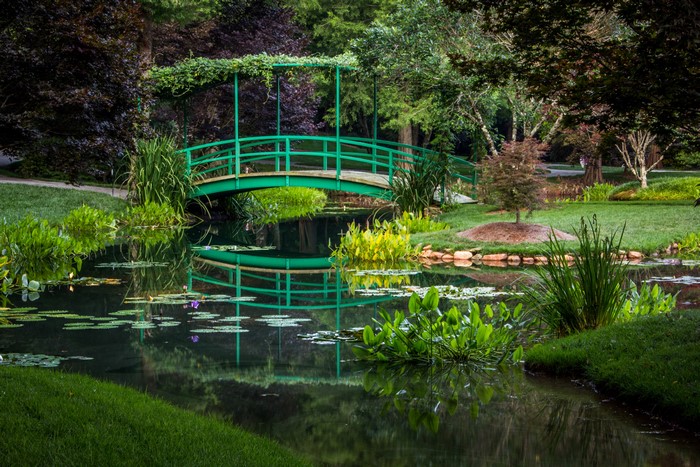 Green bridge over a pond at Gibbs Gardens, USA