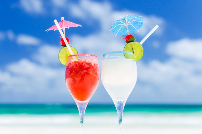 Two tropical cocktails on a beach