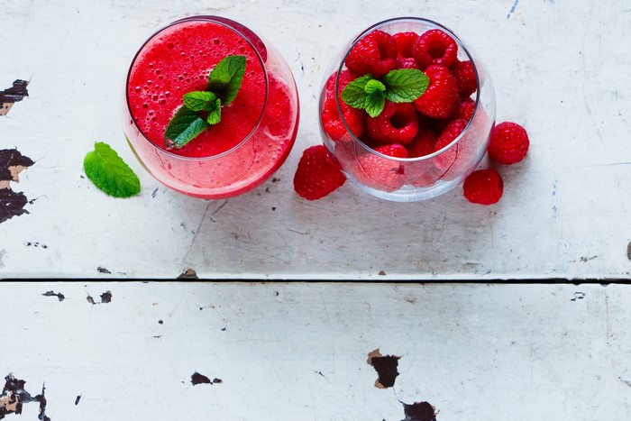 Raspberry smoothie and raspberries in glasses