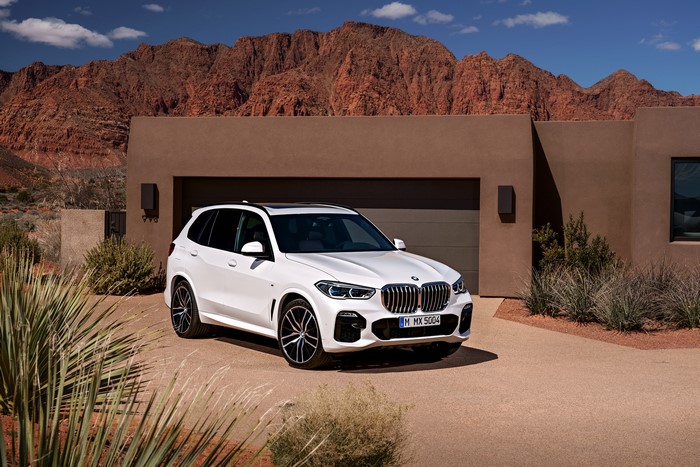 White BMW X5 xDrive30d M Sport parked in desert landscape