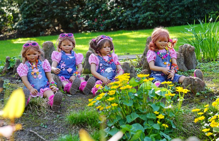 Four dolls in a park