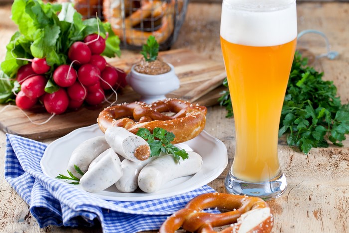 Beer, Sausages, Pretzels, and Radishes on a Table