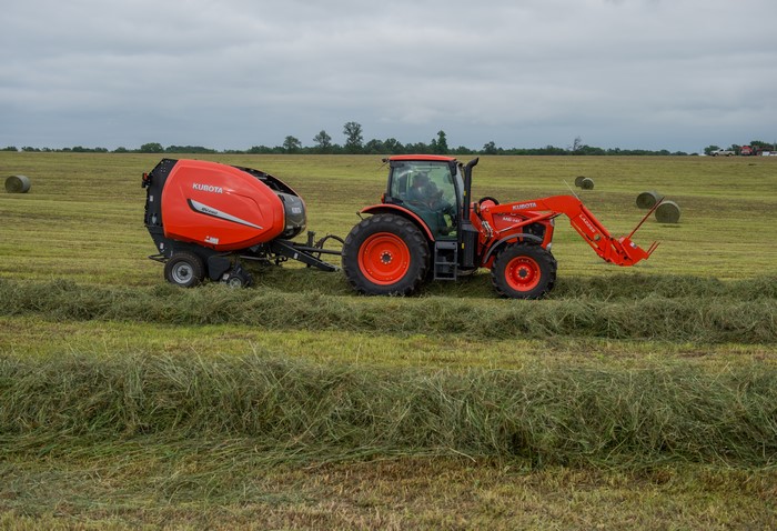 Kubota Tractor and Baler in a Field