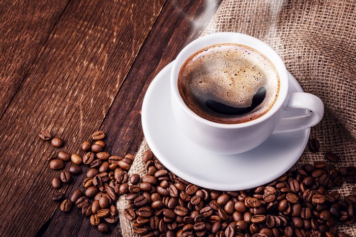Cup of Coffee with Beans on Wood