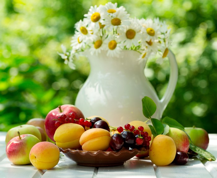 Still life of fruits and flowers in a vase