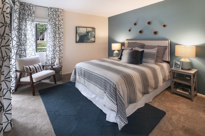 Bedroom with Bed, Armchair, and Curtains