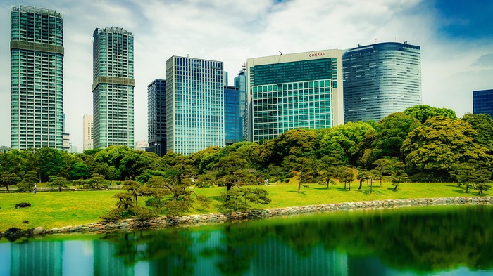 Tokyo skyscrapers and a Japanese garden with a pond