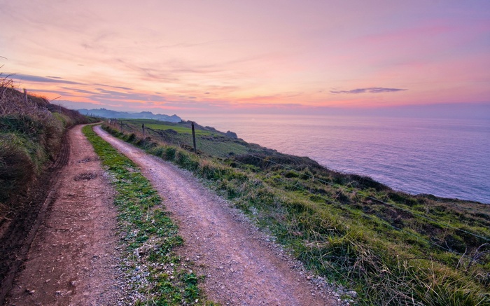 Coastal path at sunset overlooking the ocean