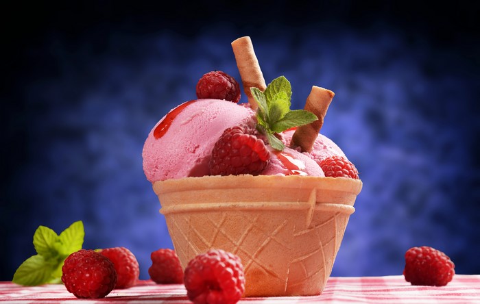 Ice cream with raspberries and wafer sticks