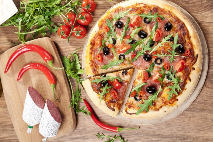 Pizza with Salami, Tomatoes, Olives, and Arugula
