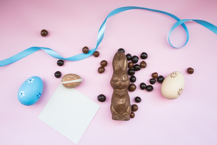 Easter chocolate bunny and eggs with blue ribbon