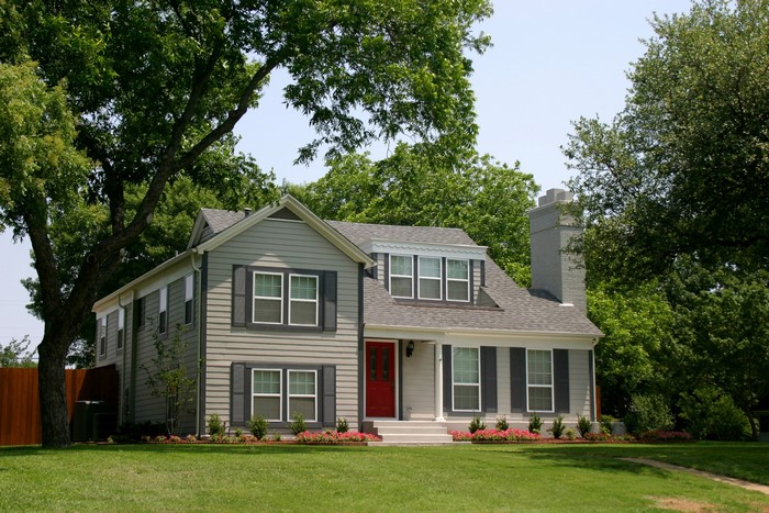 Two-story house with red door and gray shutters