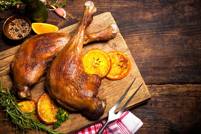 Roast Duck Legs with Oranges on Cutting Board