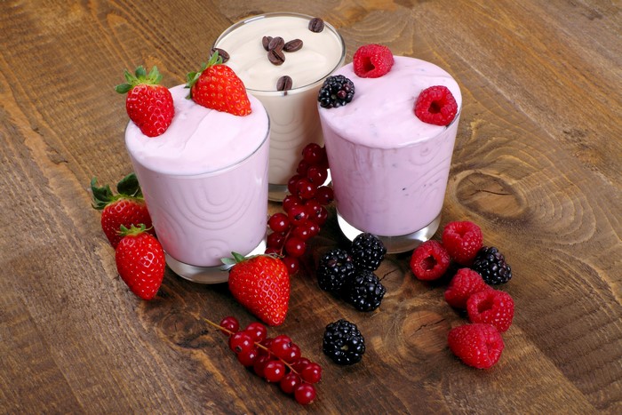 Three glasses of yogurt with berries and currants