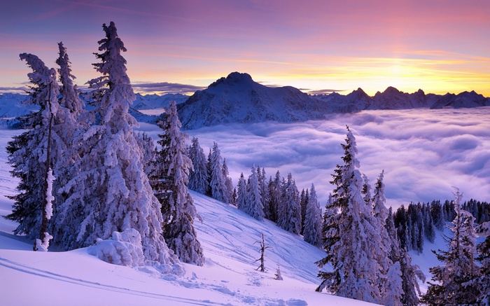 Snowy mountain landscape at sunrise with clouds