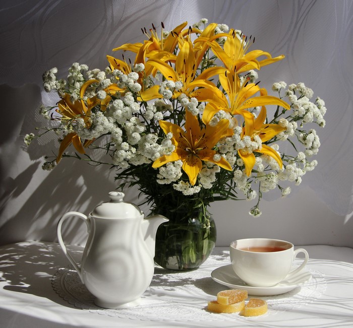 Still-life with yellow lilies, tea set, and marmalade