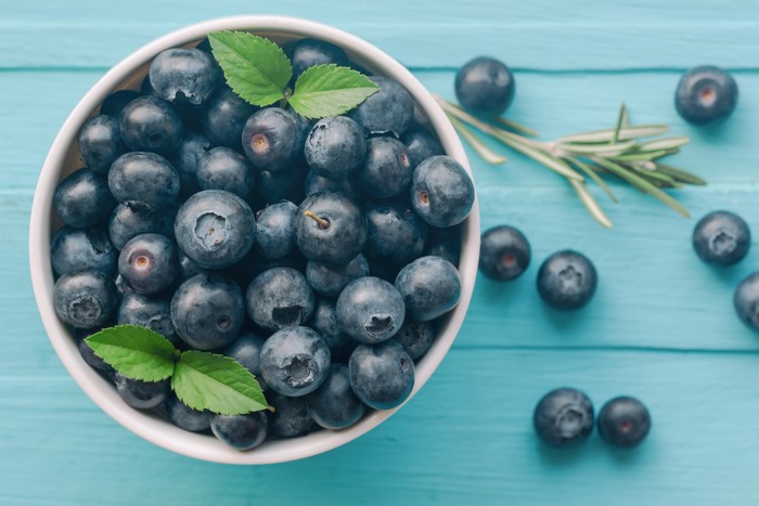 Blueberries in a bowl with rosemary sprigs