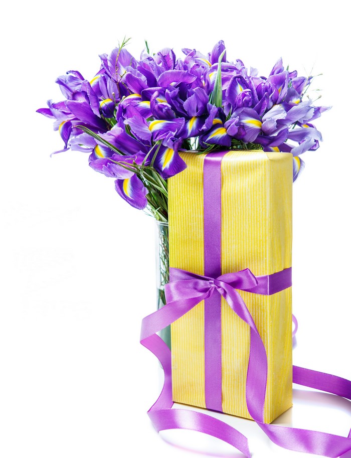 Bouquet of purple irises with a yellow gift box