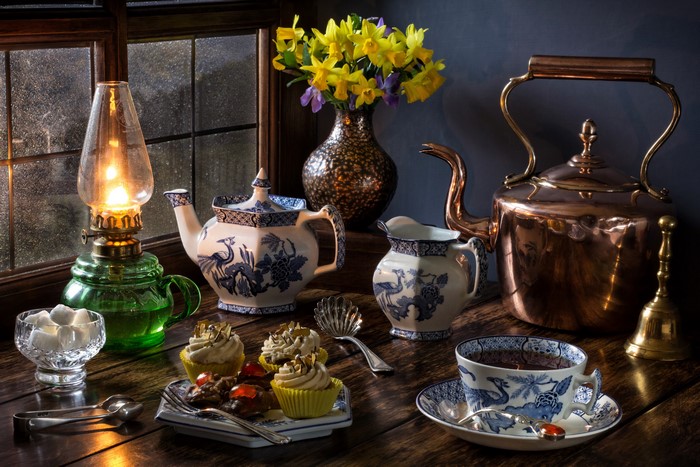 Still-life with tea set, cupcakes, and daffodils