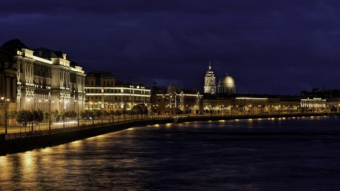 Night view of St. Petersburg embankment with illuminated buildings